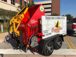 Red and white trash bin cleaning truck with yellow hydraulic lift parked on a street, displaying company logo and contact information for a professional trash can cleaning service.