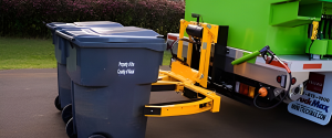 Trash bin cleaning truck lifting residential trash cans for professional cleaning