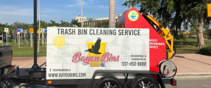 Bayou Bins trash bin cleaning service truck with logo and contact information