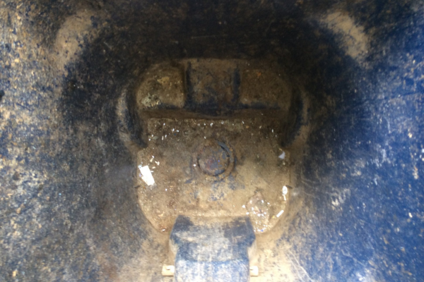A close-up, top-down view of a royal blue plastic surface with a circular indentation and a raised square shape.